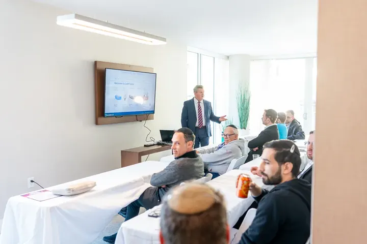 Breakout CE session with an instructor presenting to a small group of attendees in a bright hotel room