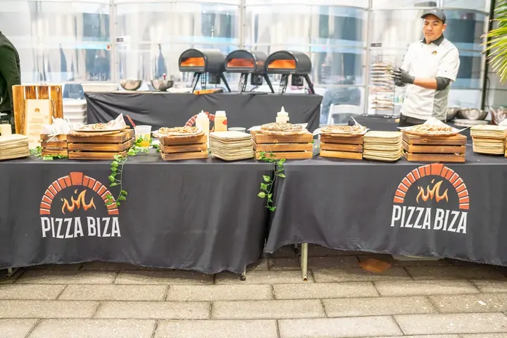 Pizza Biza catering tables with freshly made kosher pizzas at the conference