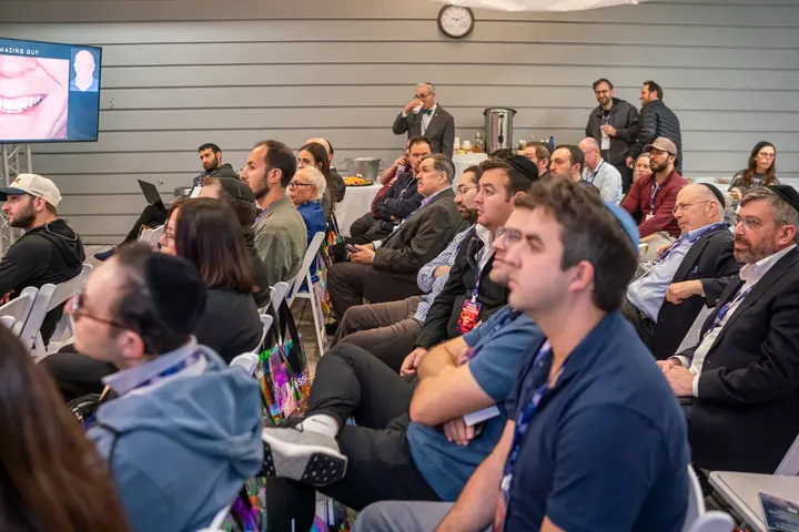 Large audience of dental professionals attentively watching a CE lecture at the conference