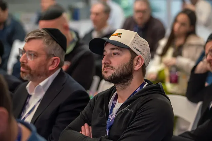 Dental professionals attentively watching a CE lecture at the Dental Wisdom Conference