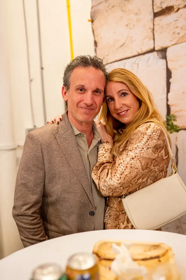 A couple smiling together at a conference dinner